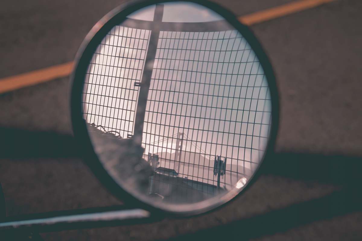 bridge photo of round black framed motorcycle side mirror racket